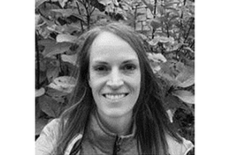 A woman in front of plants