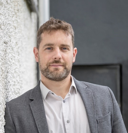 A man in front of a wall